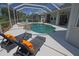 Relaxing pool area with chaise lounges and a serene atmosphere, perfect for enjoying sunny days in a screened-in enclosure at 260 Rotonda E Blvd, Rotonda West, FL 33947