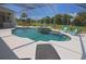 Sparkling pool with built-in spa and waterfall feature, surrounded by comfortable lounge chairs in a screened-in lanai at 260 Rotonda E Blvd, Rotonda West, FL 33947