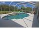 Sparkling pool and spa area with screened enclosure and outdoor furniture at 260 Rotonda E Blvd, Rotonda West, FL 33947