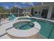Large pool and spa area with screened enclosure, seating, and access to the home at 260 Rotonda E Blvd, Rotonda West, FL 33947