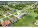 Drone shot of the house with a pool, neatly landscaped lawn and neighborhood context at 26090 Rampart Blvd, Punta Gorda, FL 33983