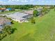 Aerial view shows the rear of homes with lanais and large green spaces, surrounded by lush landscaping at 26090 Rampart Blvd, Punta Gorda, FL 33983