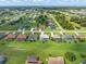Wide aerial of the community featuring well-maintained homes, green spaces, and a waterway at 26090 Rampart Blvd, Punta Gorda, FL 33983