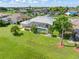 Aerial view showcases the backyard with screened lanai, lush landscaping, and surrounding green lawn at 26090 Rampart Blvd, Punta Gorda, FL 33983