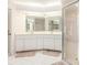 Well-lit bathroom features a double vanity with mirrors and a glass enclosed shower stall at 26090 Rampart Blvd, Punta Gorda, FL 33983