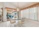 Bright dining area featuring a glass table, white chairs, and access to a patio at 26090 Rampart Blvd, Punta Gorda, FL 33983