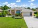 Charming single-story home features a well-manicured lawn and attached two car garage at 26090 Rampart Blvd, Punta Gorda, FL 33983