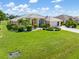 Beautifully landscaped single-Gathering home featuring lush green lawn and mature landscaping at 26090 Rampart Blvd, Punta Gorda, FL 33983