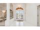 Elegant foyer with tile flooring, decorative lighting, and beautifully decorated glass front doors at 26090 Rampart Blvd, Punta Gorda, FL 33983