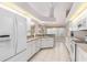 Well-lit kitchen offering lots of natural light and white cabinets with modern appliances at 26090 Rampart Blvd, Punta Gorda, FL 33983