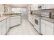 Well-lit kitchen with lots of counter space, white cabinetry, and modern appliances at 26090 Rampart Blvd, Punta Gorda, FL 33983