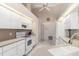 Bright kitchen featuring white cabinetry, modern appliances, and a neutral countertop at 26090 Rampart Blvd, Punta Gorda, FL 33983