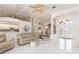 Open-concept living area with tile floors, neutral color palette, and easy access to kitchen at 26090 Rampart Blvd, Punta Gorda, FL 33983