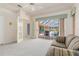 Open living room features an exterior window, seating, and pool access at 26090 Rampart Blvd, Punta Gorda, FL 33983