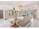 Spacious living room with tile flooring, decorative cabinets and large sliding doors to outside at 26090 Rampart Blvd, Punta Gorda, FL 33983