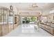Bright living room with white tile floors, modern furniture, and sliding glass doors to lanai at 26090 Rampart Blvd, Punta Gorda, FL 33983