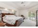 Spacious main bedroom with a large bed, carpet, and access to the outdoors at 26090 Rampart Blvd, Punta Gorda, FL 33983