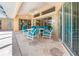 Covered outdoor patio featuring a dining table, chairs, and sliding glass doors leading inside at 26090 Rampart Blvd, Punta Gorda, FL 33983