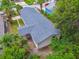 Overhead view of the property, showing the roof and surrounding trees in a lush neighborhood at 2626 E 38Th Ave, Tampa, FL 33610