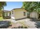 Exterior view of a home's back with a storage shed and screened-in porch at 2626 E 38Th Ave, Tampa, FL 33610