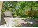 Backyard with a storage shed and natural landscaping at 2626 E 38Th Ave, Tampa, FL 33610