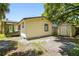 View of the side and back of the house showing a storage shed and enclosed back porch at 2626 E 38Th Ave, Tampa, FL 33610