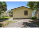 View of the side and back of the house showing a storage shed at 2626 E 38Th Ave, Tampa, FL 33610