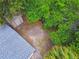A spacious backyard featuring a shed, mature trees, and tropical landscaping at 2626 E 38Th Ave, Tampa, FL 33610