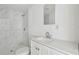 Bathroom featuring a new white vanity, toilet, and a modern glass enclosed shower with marble pattern at 2626 E 38Th Ave, Tampa, FL 33610