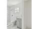 Bathroom features a remodeled shower with marble-patterned tile and updated vanity at 2626 E 38Th Ave, Tampa, FL 33610