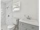 Bathroom showcasing a remodeled shower with marble-patterned tile, an updated vanity, and natural light at 2626 E 38Th Ave, Tampa, FL 33610