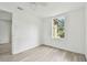 Bright bedroom featuring laminate floors, a window, and ceiling fan at 2626 E 38Th Ave, Tampa, FL 33610