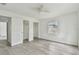 Bright bedroom with ceiling fan, white walls, a window, and ample closet space at 2626 E 38Th Ave, Tampa, FL 33610