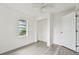 Bright bedroom with laminate flooring, a window, closet, and white walls at 2626 E 38Th Ave, Tampa, FL 33610
