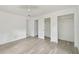 Bedroom with ceiling fan, two closets, access to additional rooms, and neutral gray flooring at 2626 E 38Th Ave, Tampa, FL 33610