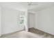 Bright bedroom features a ceiling fan, closet, and natural light from the window at 2626 E 38Th Ave, Tampa, FL 33610