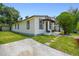Exterior view of a home with a well-kept lawn, front porch, and off-street parking at 2626 E 38Th Ave, Tampa, FL 33610