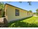 View of side of house showing grass and landscaping at 2626 E 38Th Ave, Tampa, FL 33610