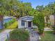 Charming bungalow with inviting front yard, stone pathway, and lush, mature landscaping at 2626 E 38Th Ave, Tampa, FL 33610