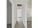 Hallway featuring neutral paint, and light gray laminate flooring at 2626 E 38Th Ave, Tampa, FL 33610