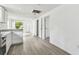 Open floor plan with a kitchen that has stainless steel appliances and new floors at 2626 E 38Th Ave, Tampa, FL 33610