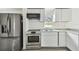 The kitchen has a stainless steel fridge and oven with a window for natural light at 2626 E 38Th Ave, Tampa, FL 33610
