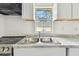 Close-up of the kitchen area shows the stainless steel sink with a window view at 2626 E 38Th Ave, Tampa, FL 33610