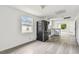 Bright kitchen with new stainless steel appliances, white cabinets, and light gray laminate flooring at 2626 E 38Th Ave, Tampa, FL 33610