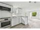 Bright kitchen features white cabinets, stainless steel appliances, and sleek countertops at 2626 E 38Th Ave, Tampa, FL 33610