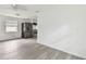 Bright kitchen featuring new stainless steel appliances, white cabinets, and light gray laminate flooring at 2626 E 38Th Ave, Tampa, FL 33610