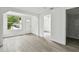 Bright living room with laminate flooring and ample natural light from a large front window at 2626 E 38Th Ave, Tampa, FL 33610