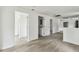 Open floor plan with wood-style flooring, white walls, and multiple doorways leading to other rooms at 2626 E 38Th Ave, Tampa, FL 33610