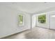 Bright living room featuring laminate flooring, two large windows, and a freshly painted white interior at 2626 E 38Th Ave, Tampa, FL 33610