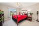 Bright bedroom with a ceiling fan, large window, and comfortable bed with wrought iron frame at 311 Garvin St # 301B, Punta Gorda, FL 33950